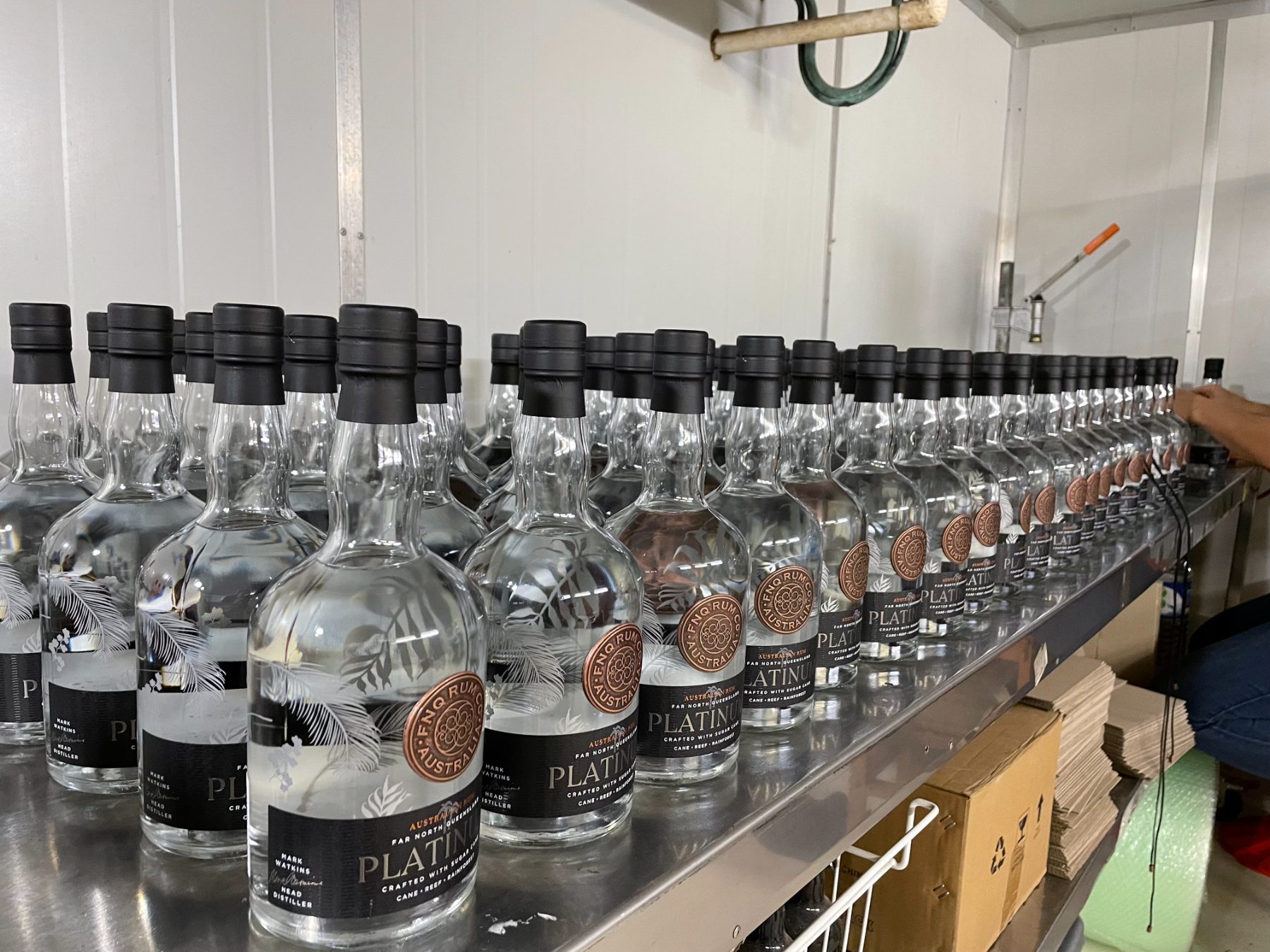 Platinum bottles filled and capped on the bottling bench at Walkamin